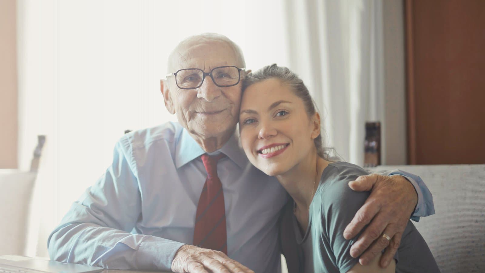 Adult daughter supporting aging parent